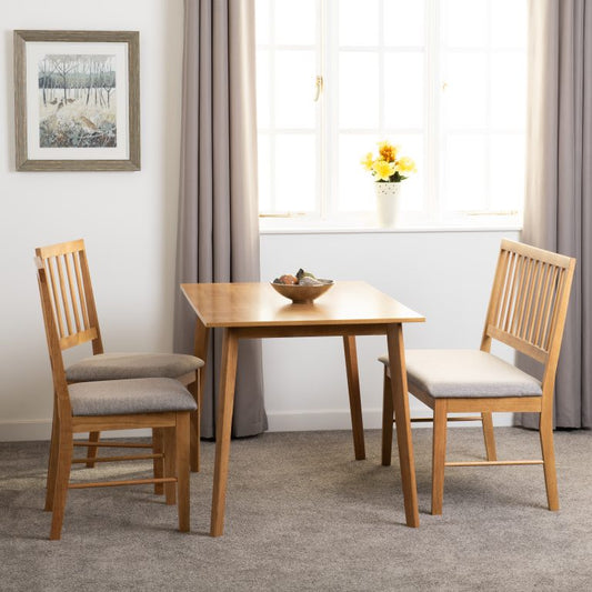 Austin Dining table Set with 2 chairs and a bench in a room with a window and framed picture.