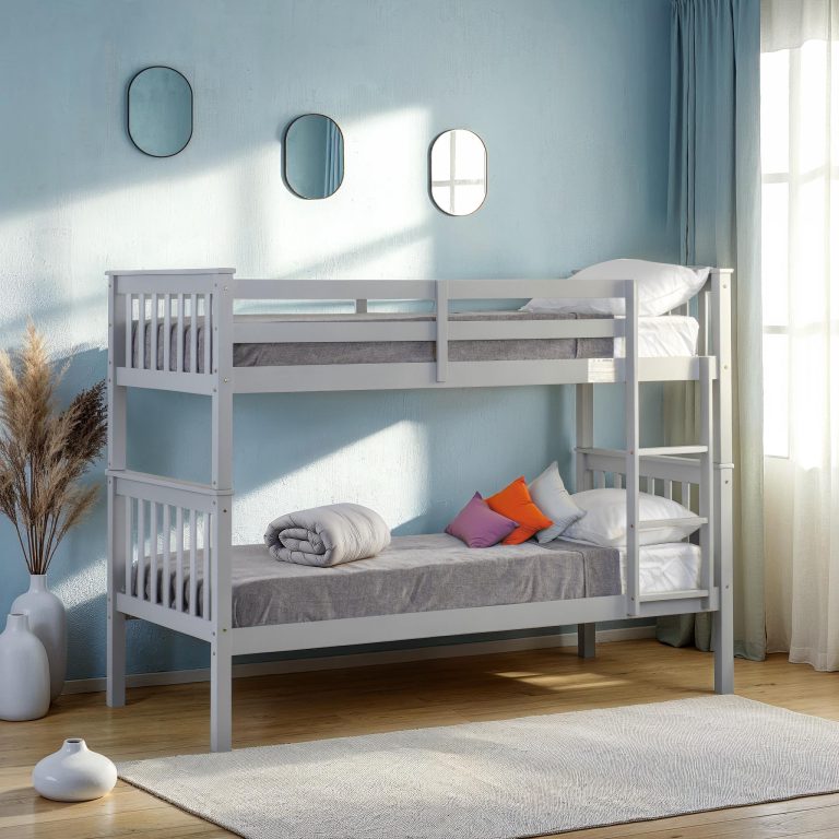Erin grey bunk bed in a room with light blue walls, a rug, and decorative elements.