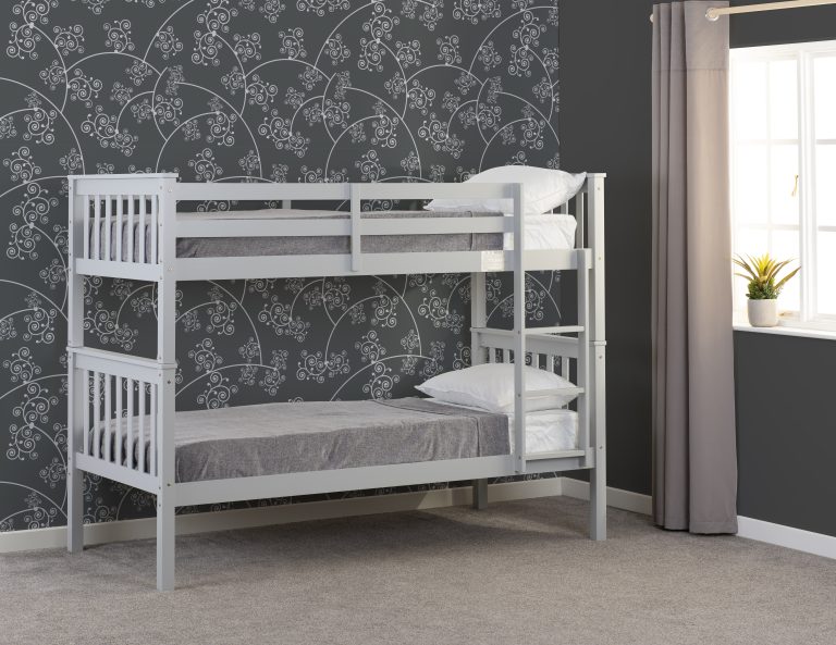 Erin grey bunk bed in a room with floral wallpaper and a window.