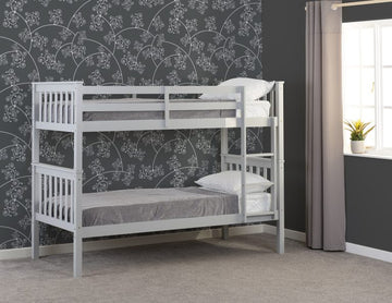 Erin grey bunk bed in a room with floral wallpaper and a window.