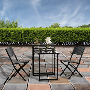 Outdoor patio set with table and chairs on a tiled patio area.