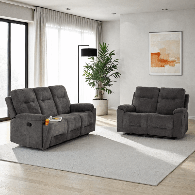 Gray sofa set in a modern living room with a plant and artwork on the wall.