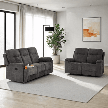 Gray sofa set in a modern living room with a plant and artwork on the wall.