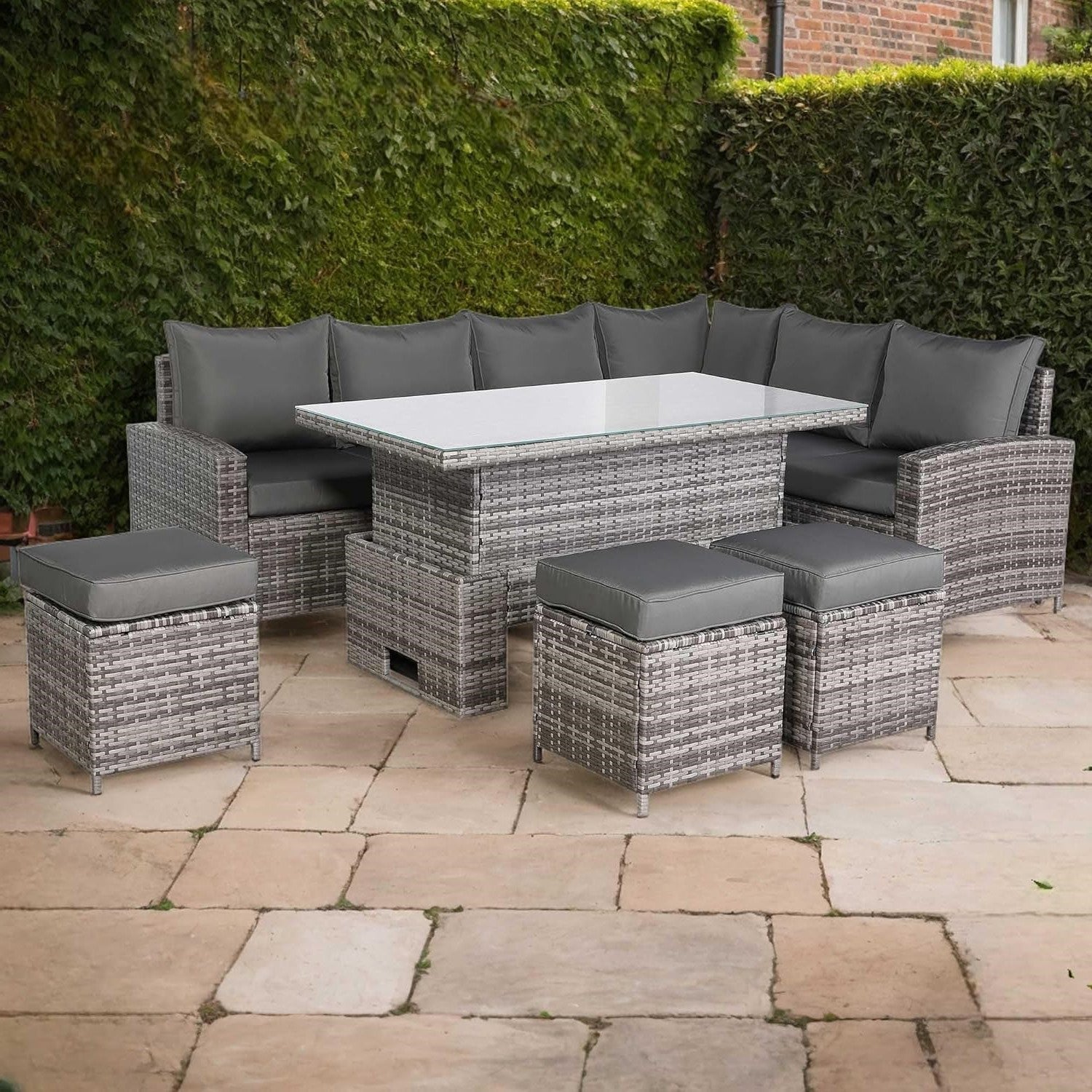 Outdoor patio set with gray cushions on a stone patio
