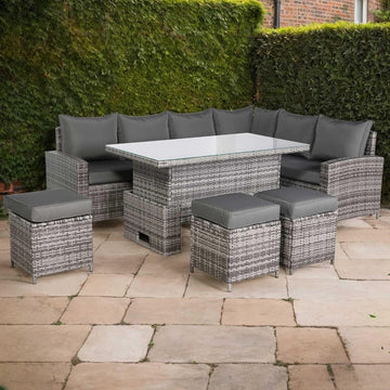 Outdoor patio set with gray cushions on a stone patio