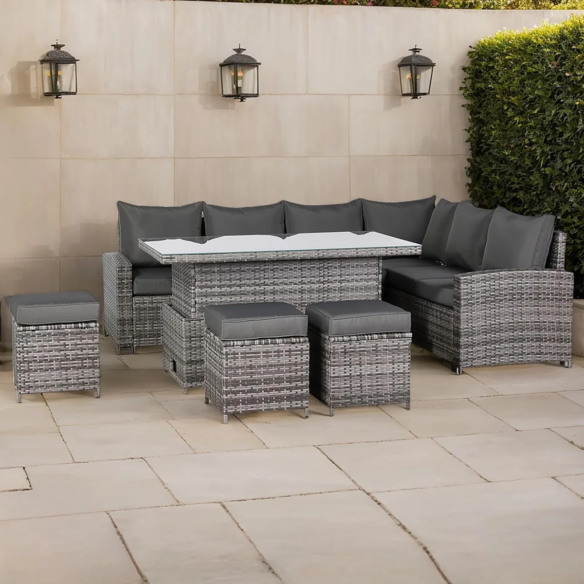Outdoor patio furniture set with gray cushions on a stone patio.
