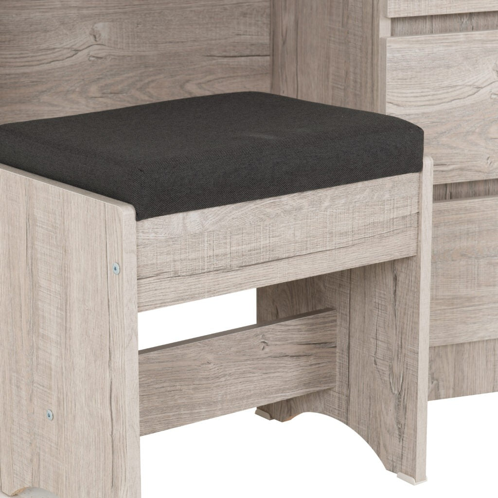 Wooden stool with a black cushion on a neutral background