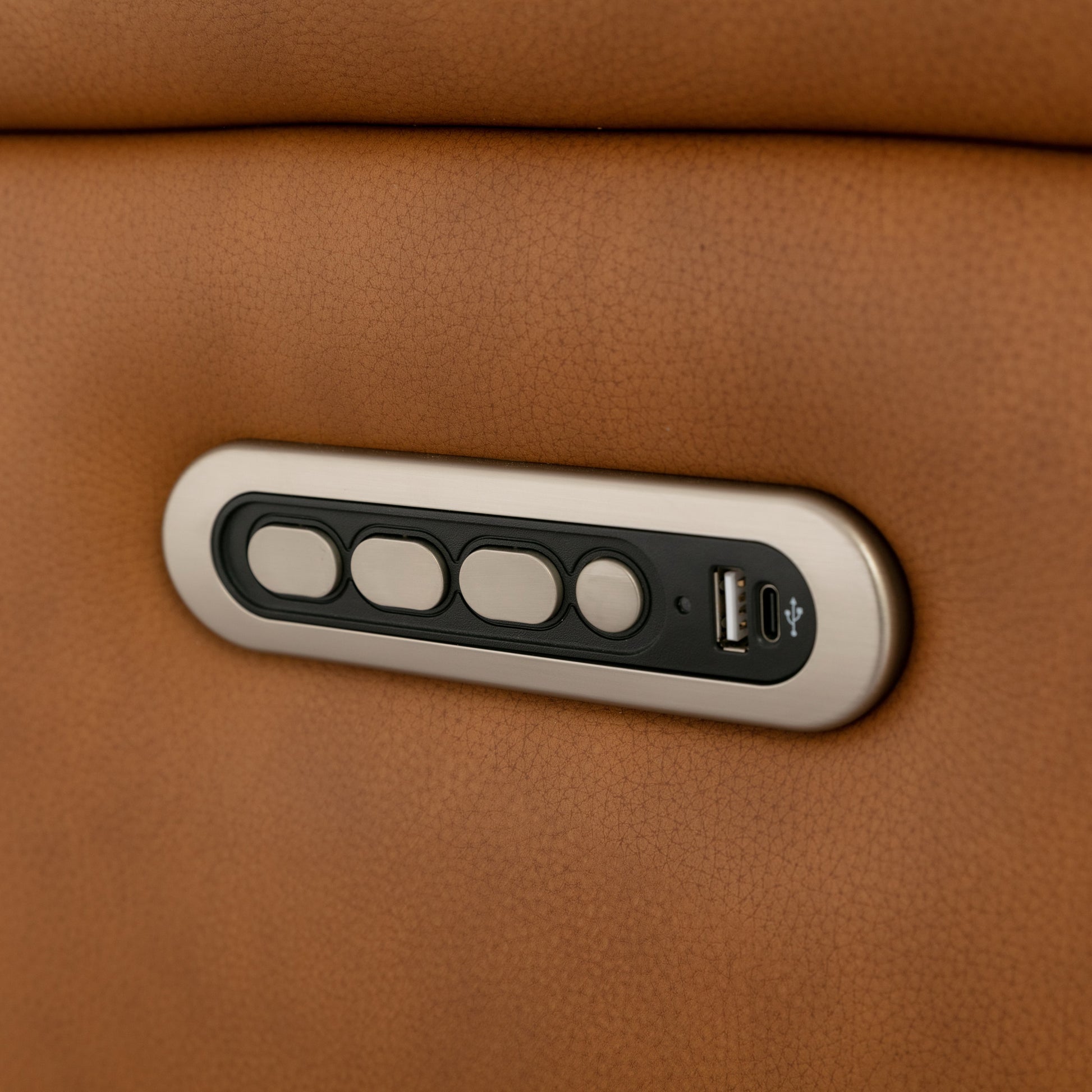 Close-up of a Prestige Armchair with a control panel featuring buttons and a USB port.