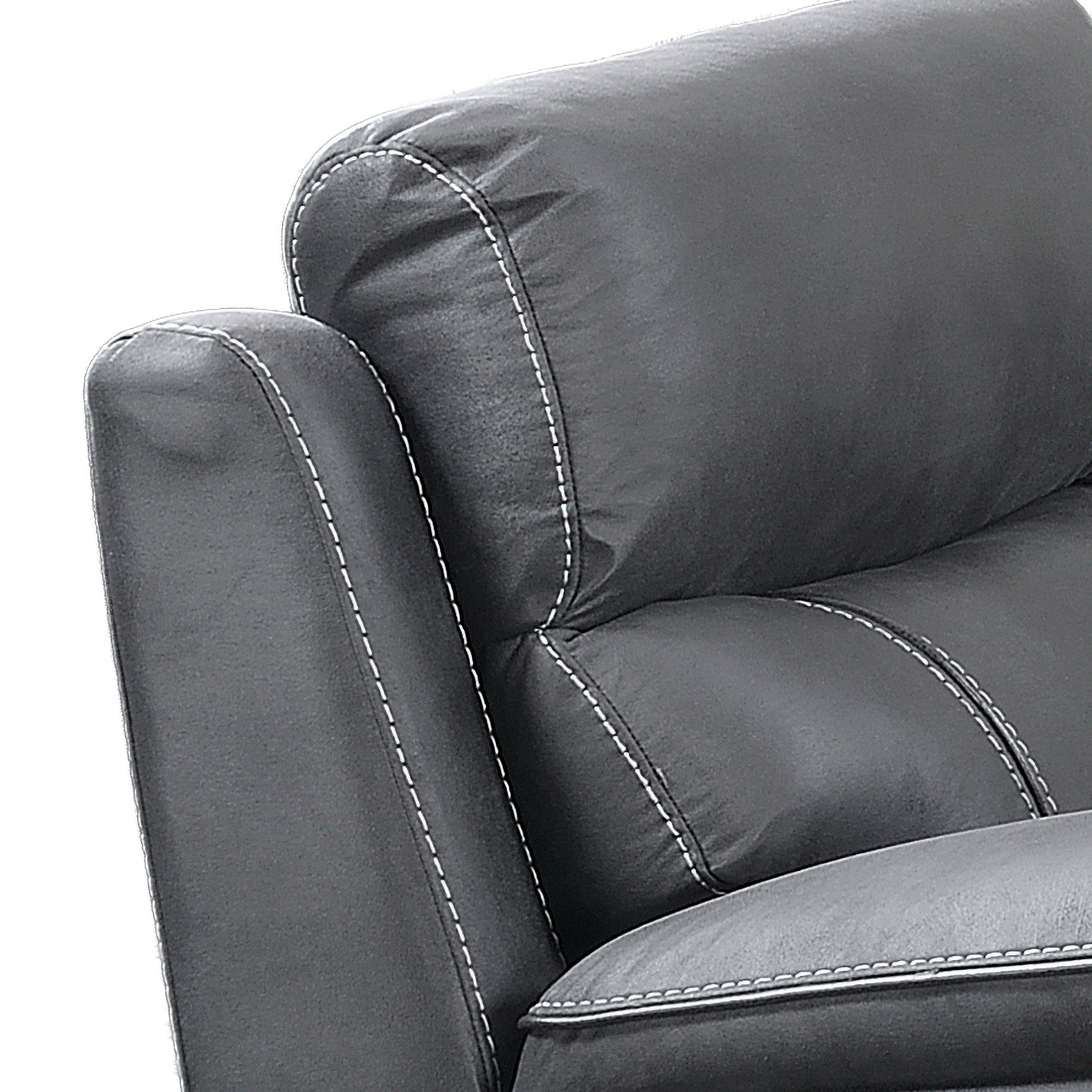 Close-up of a dark gray leather armchair showing the textured leather upholstery, contrast white stitching, and padded backrest against a white background.