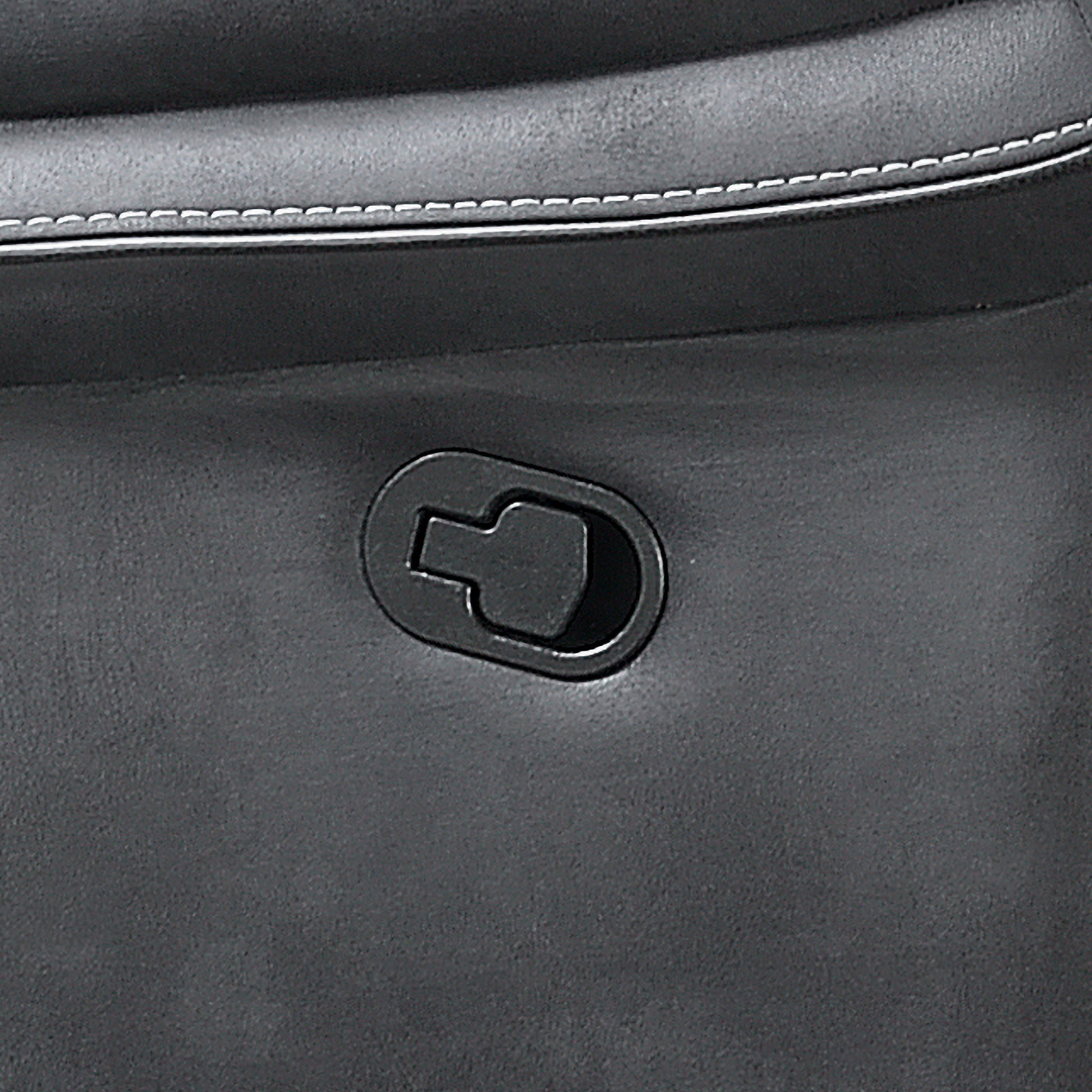Close-up detail of a dark gray leather or faux-leather bag showing a black oval metal hardware piece and white contrast stitching.