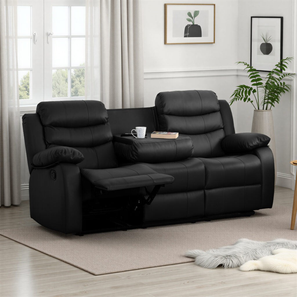 Black leather sofa in a living room setting with a plant and window in the background.