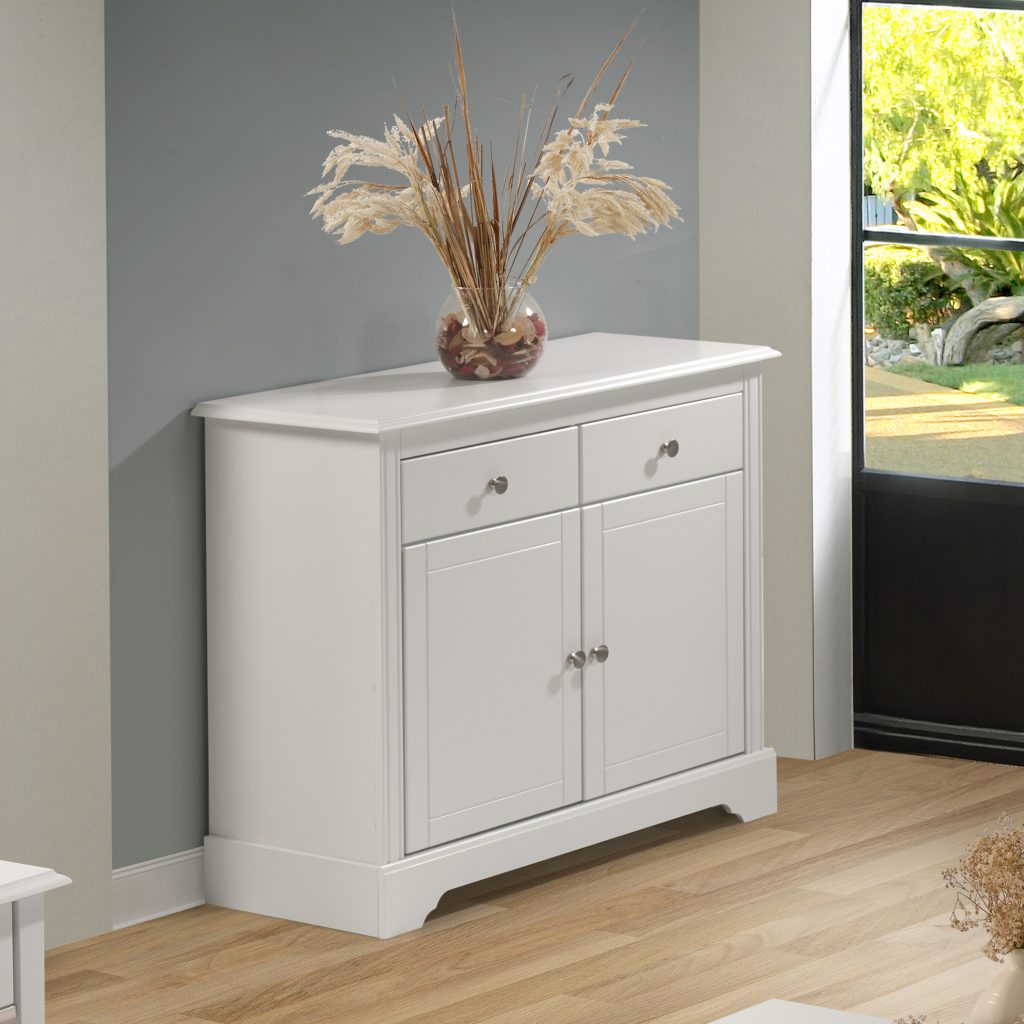 White sideboard with decorative vase and plants in a room with a window.