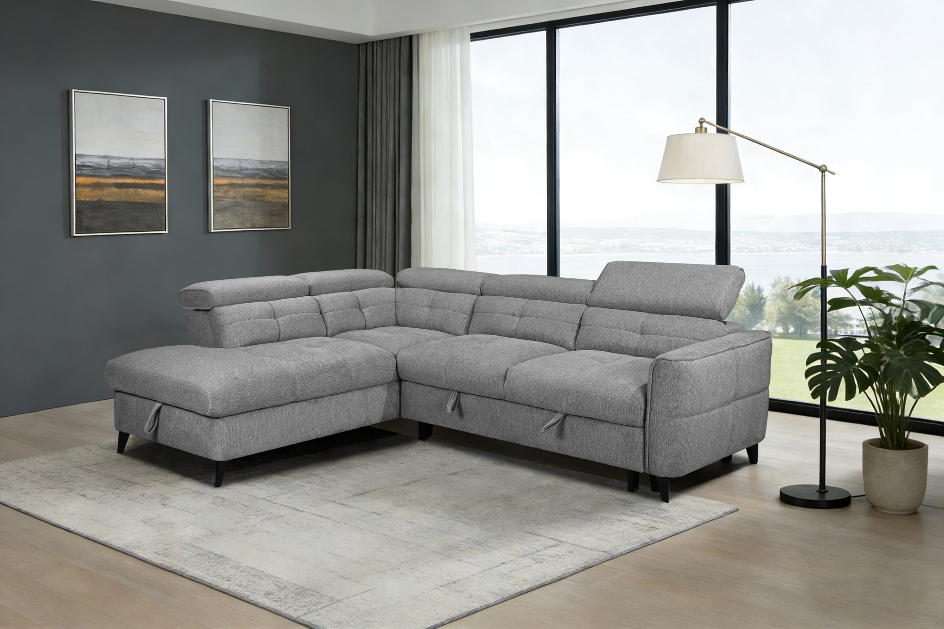 Gray sectional sofa in a living room with large windows and decor.