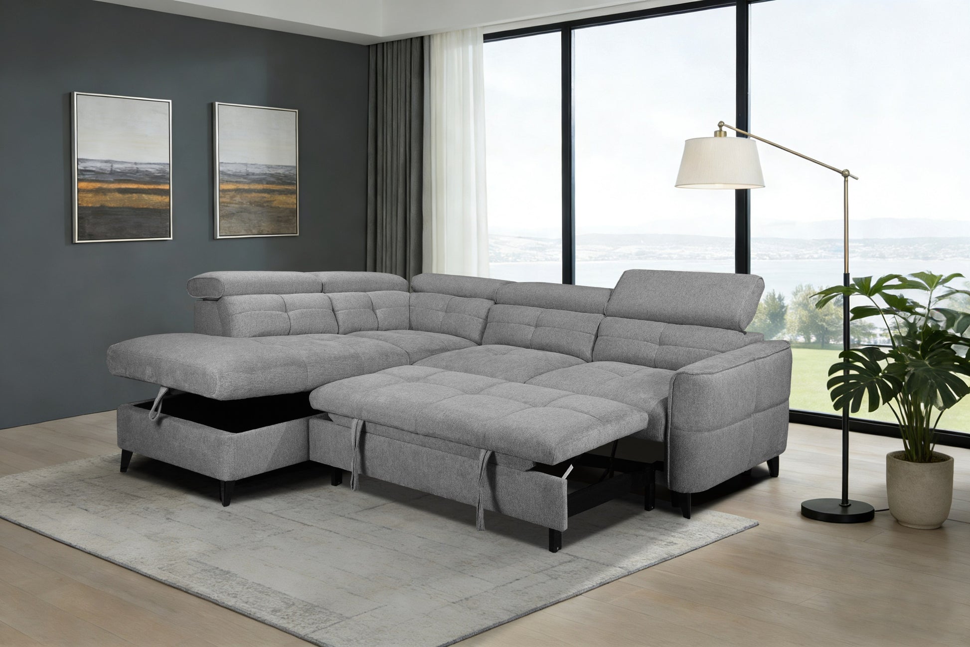 Gray sectional sofa in a living room with large windows and decor.