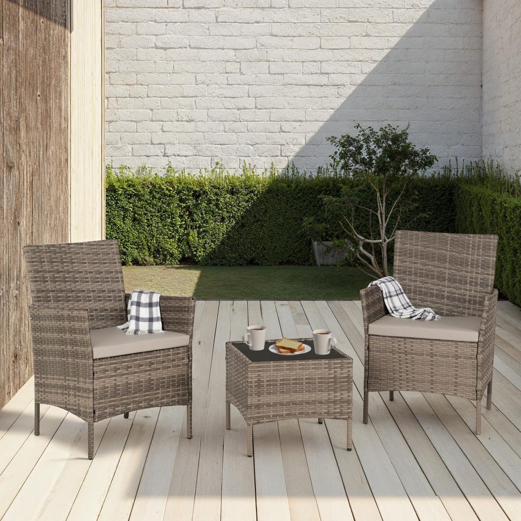 Outdoor patio set with two chairs and a small table on a wooden deck.