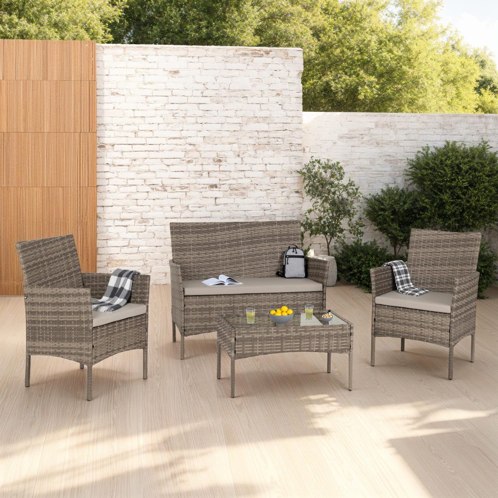 Outdoor patio set with chairs, table, and cushions on a patio.