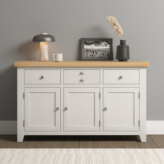 Ivory sideboard with wooden top against a gray wall
