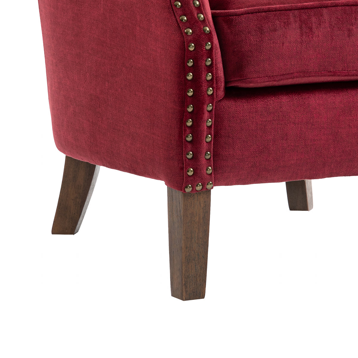 Harlow Bordeaux fabric armchair, studs and leg detail