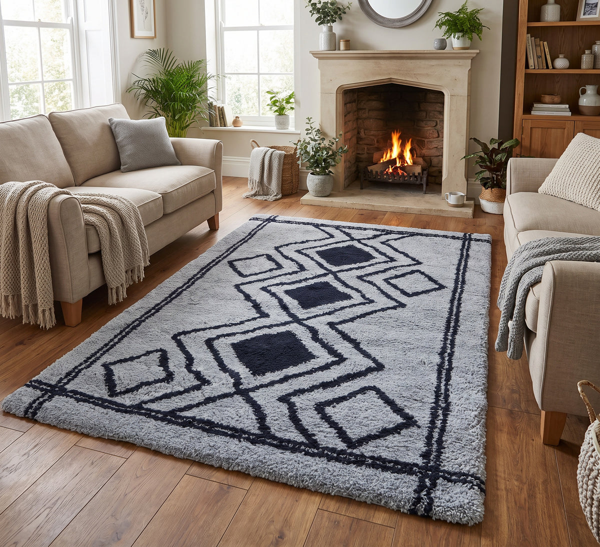 Ashton Rug - Blue Navy, blue and navy diamond-pattern rug in a living room with a fireplace