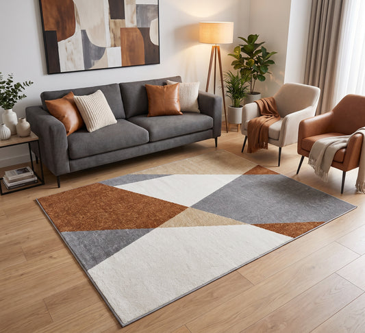Aspire Rug - 107, rust, grey and cream geometric rug beside a grey sofa on a wooden floor