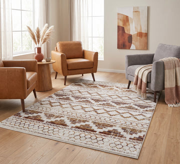 Aspire Rug - Gold, gold geometric-pattern rug beside tan armchairs and a grey sofa on a wooden floor