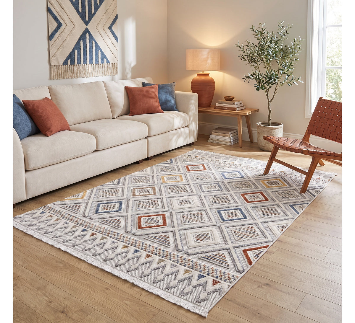 Broadway Rug - 4945A, diamond-pattern rug beside a cream sofa and rust armchair