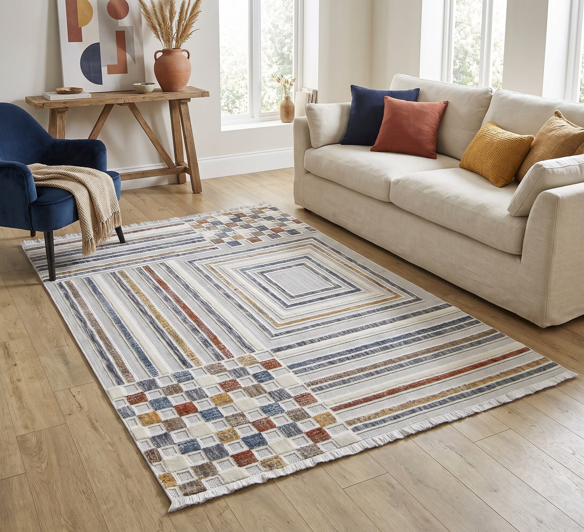 Broadway Rug - 4950A, striped and checkerboard rug beside a cream sofa