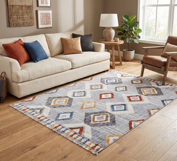 Broadway Rug - 5182A, diamond-pattern rug beside a cream sofa and wooden armchair