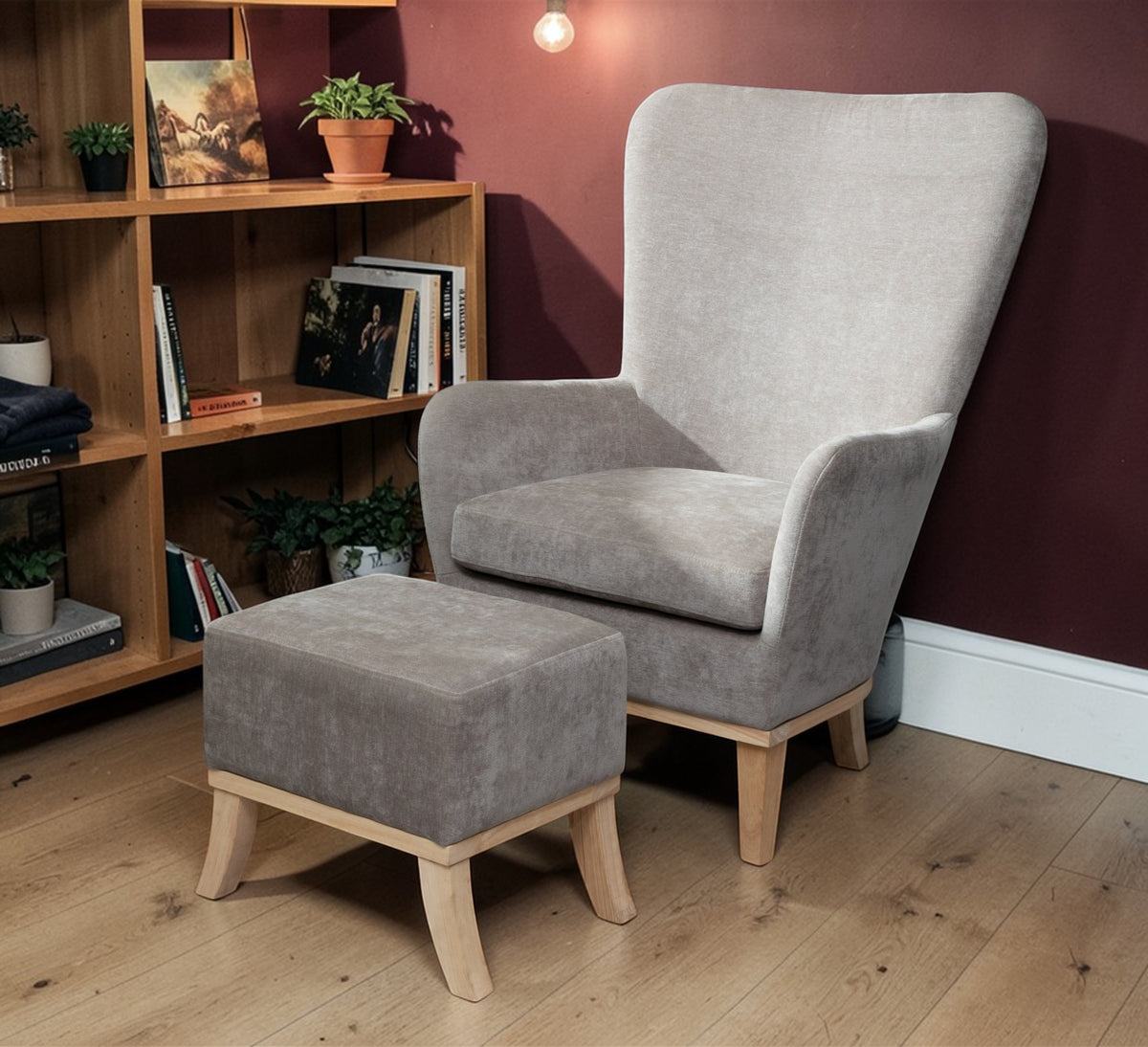 Armchair and Footstool Light Grey, chair and matching footstool beside a wooden bookshelf and burgundy wall