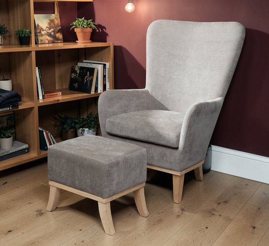 Armchair and Footstool Light Grey, chair and matching footstool beside a wooden bookshelf and burgundy wall
