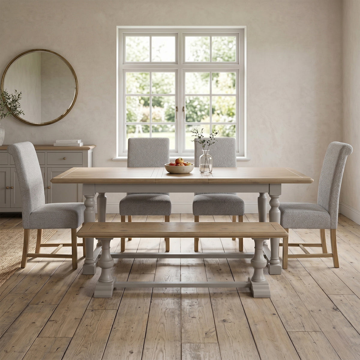 Chateau extending dining table with four grey chairs and a bench front room view