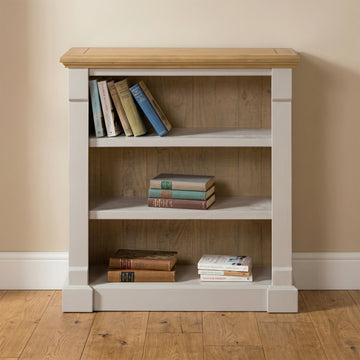 Chateau grey painted low pine bookcase in a room setting