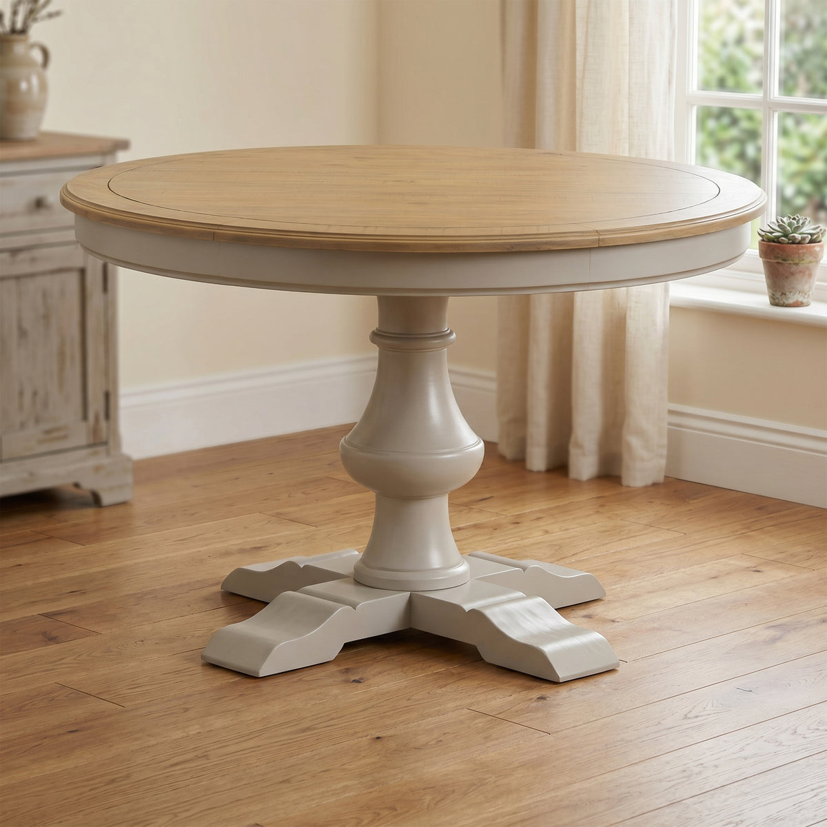 Chateau grey painted round pine dining table in a room setting
