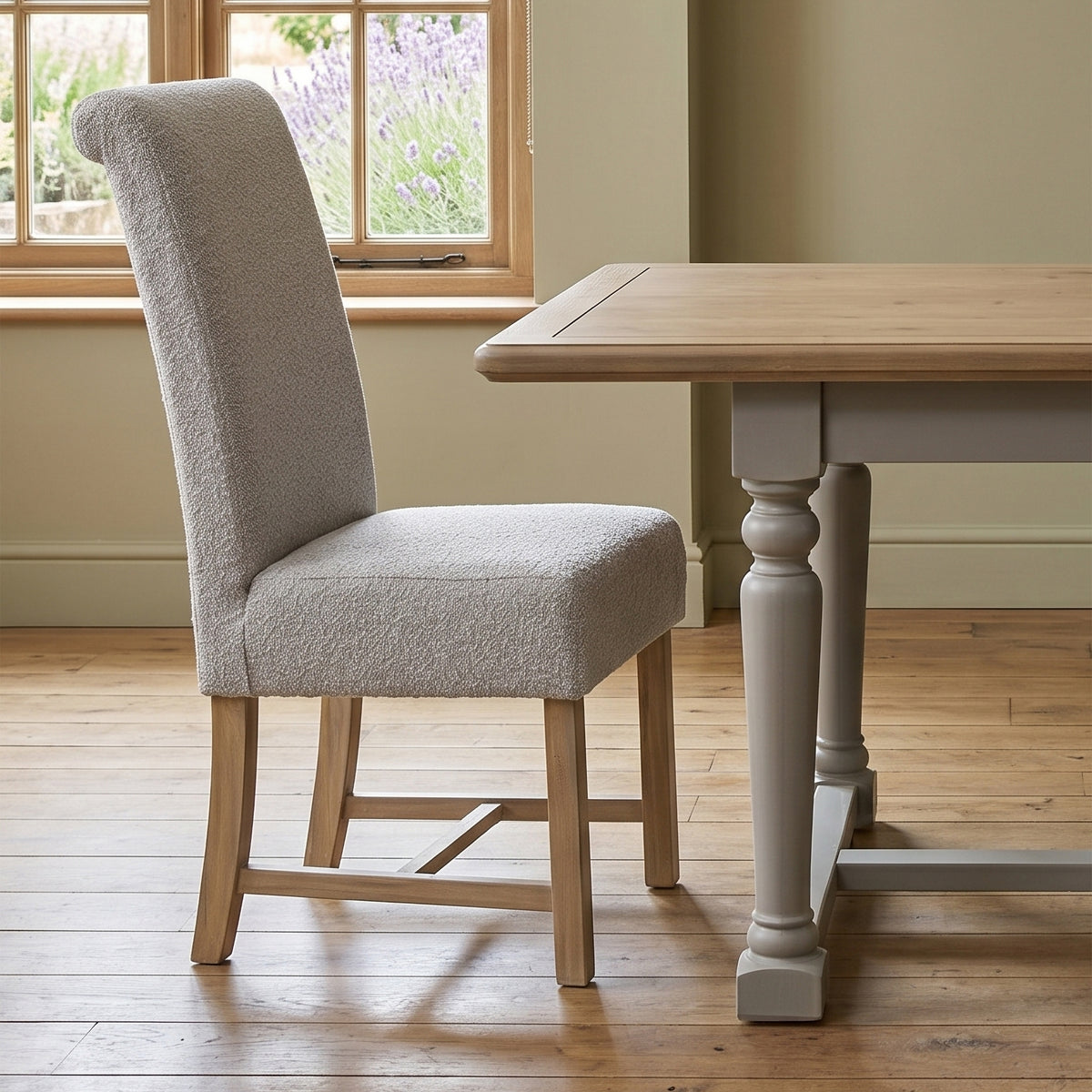 Chateau grey upholstered dining chair beside the extending table