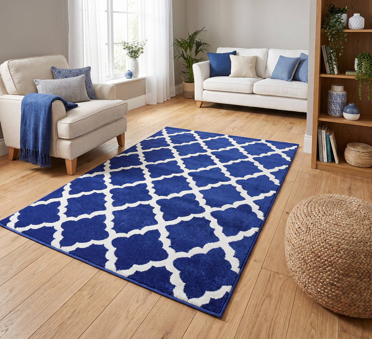 Darcy Rug Navy, navy trellis rug between cream seating in a bright room