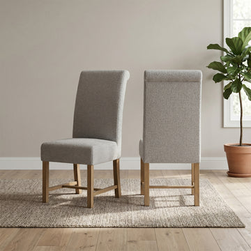 Pair of Chateau grey upholstered dining chairs in a room setting