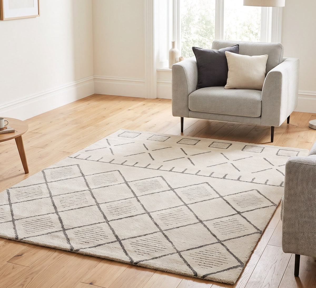 Harper 652 beige geometric rug in a bright living room beside a grey armchair