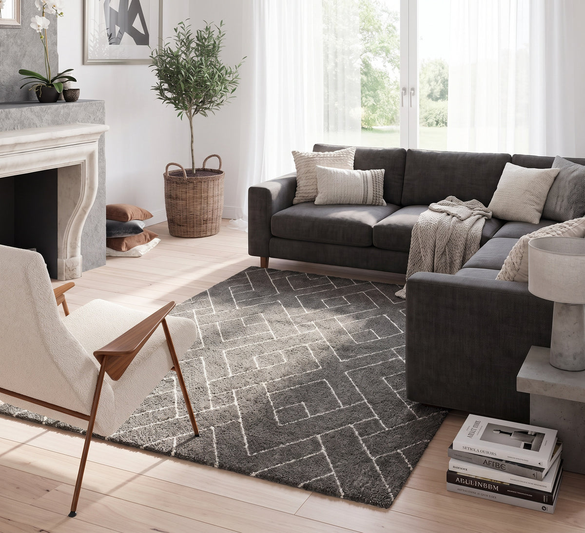 Ivy 092 grey geometric rug styled beside a charcoal sofa in a bright living room