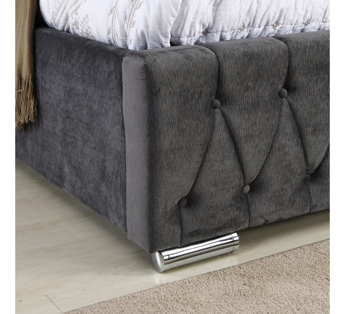 Jersey bed tufted footboard corner and metal foot, close-up
