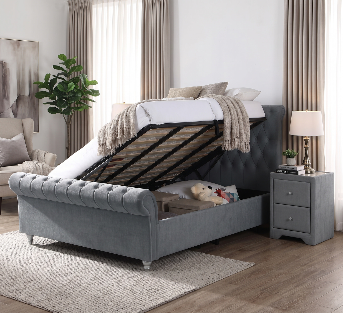 Kilkenny grey side gas-lift bed with storage raised in a room with long curtains