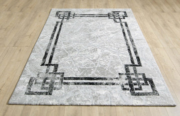 Alisa grey and black rug laid flat on a wooden floor